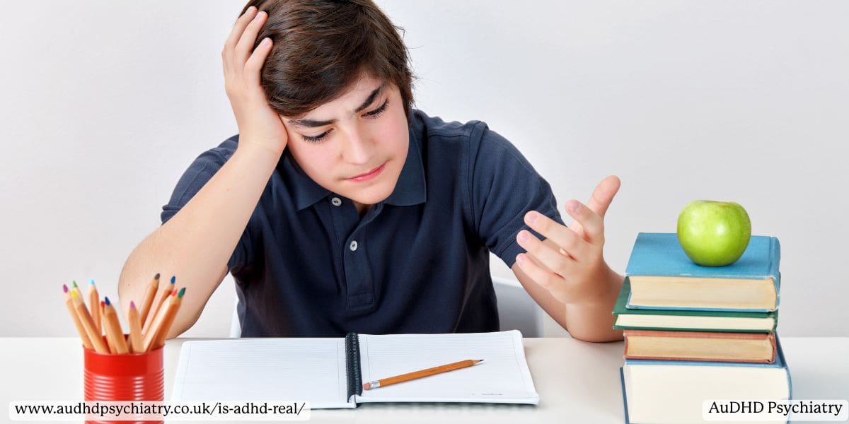  Child with ADHD showing frustration during homework with books and pencils on the table