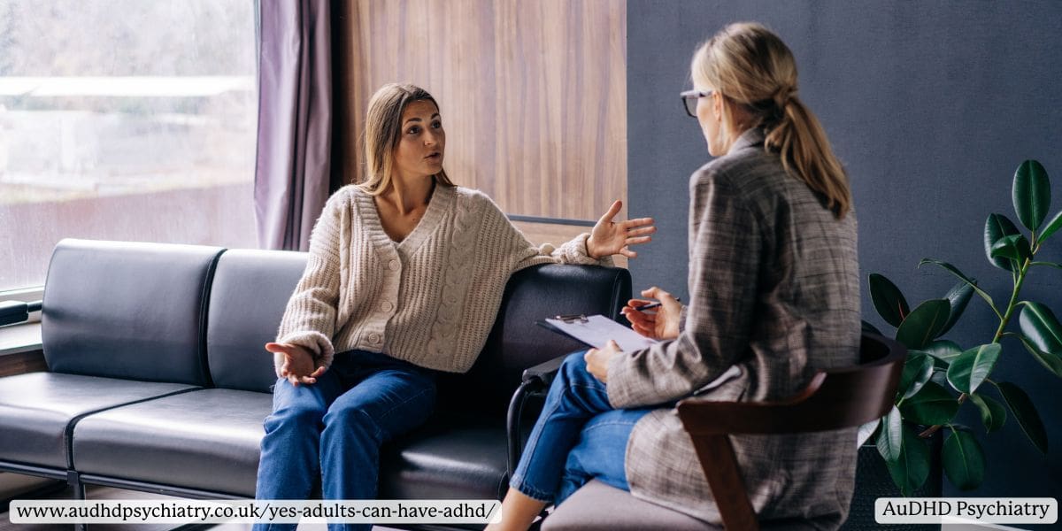Two women having a conversation in a therapy session on a modern couch