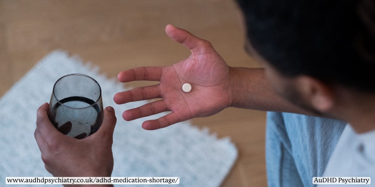 Man holding ADHD medication and glass of water