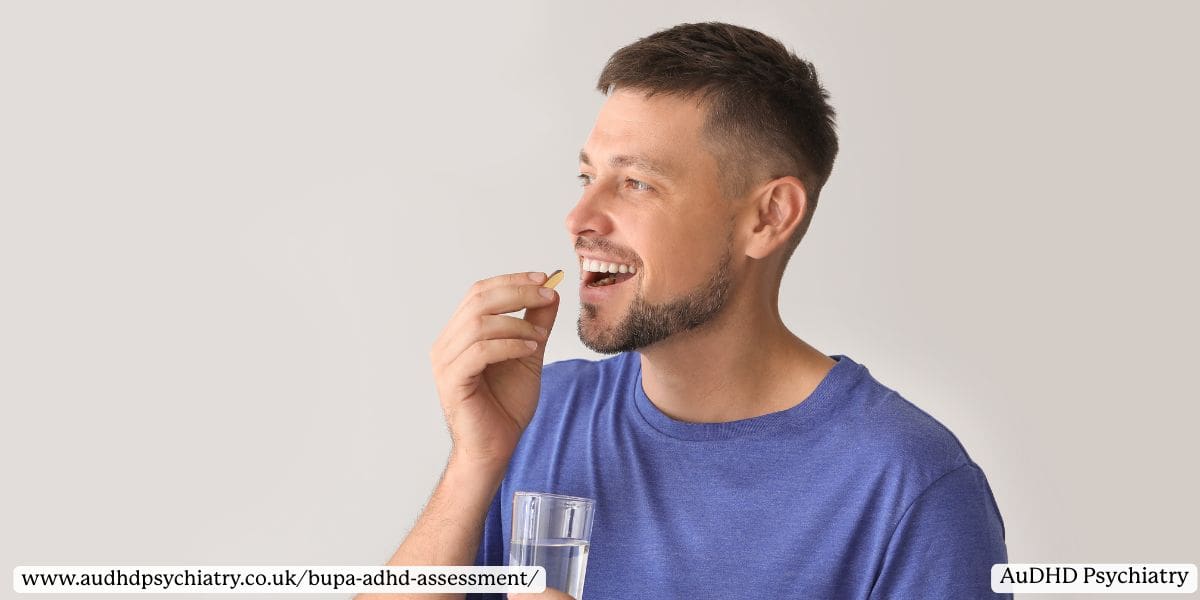 Man in blue shirt taking ADHD medication with a glass of water, representing stimulant and non-stimulant treatments