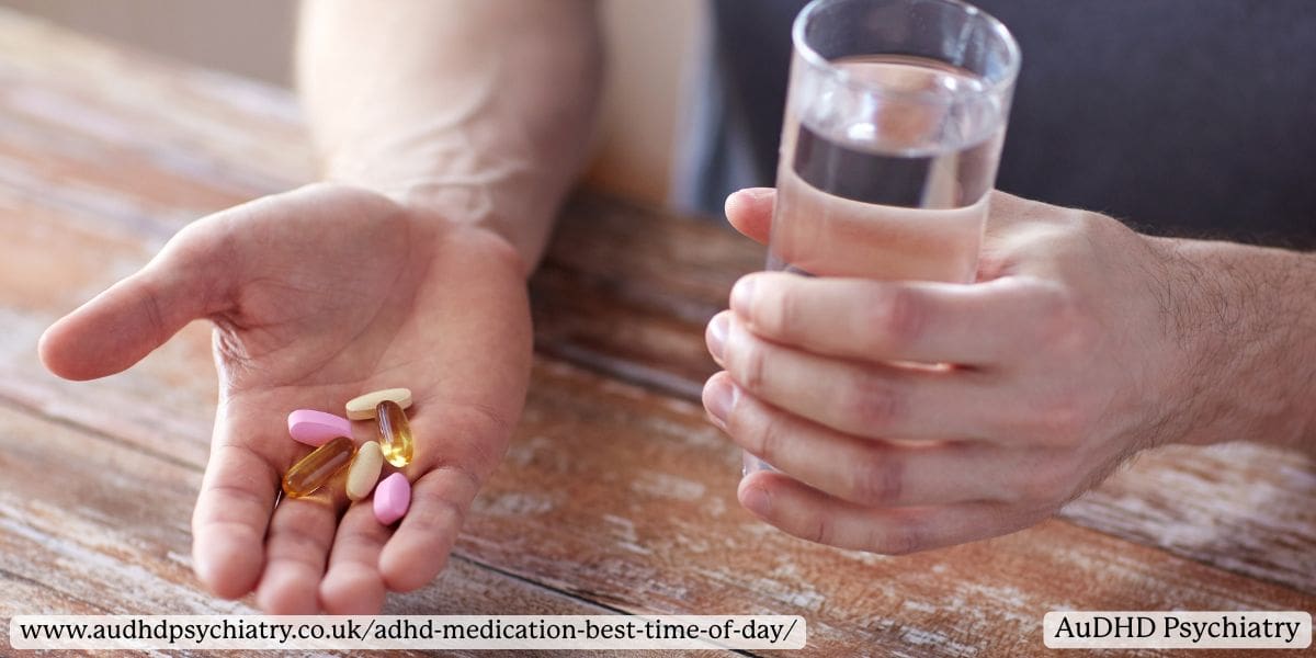Person holding assorted ADHD medication pills in one hand and a glass of water in the other