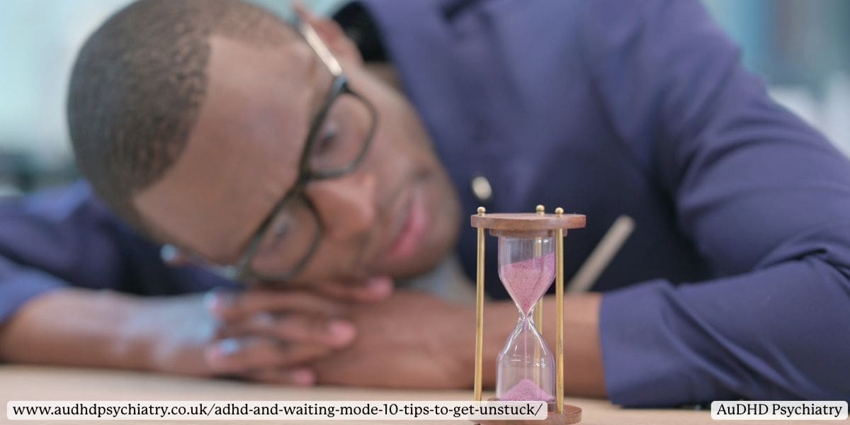 Man with ADHD staring at hourglass, symbolising time anxiety and executive dysfunction during ADHD waiting mode