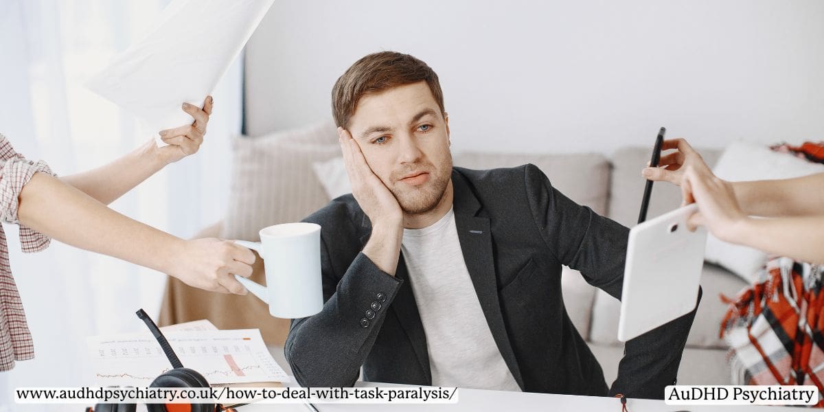 Man overwhelmed with tasks representing causes of ADHD-related task paralysis