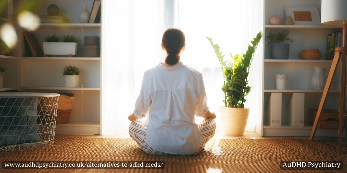 Person meditating in a peaceful room representing natural ADHD supplement alternatives