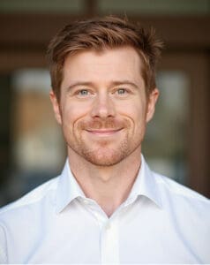 Dr. Darren O’Reilly, consultant psychologist, smiling in white shirt indoors.