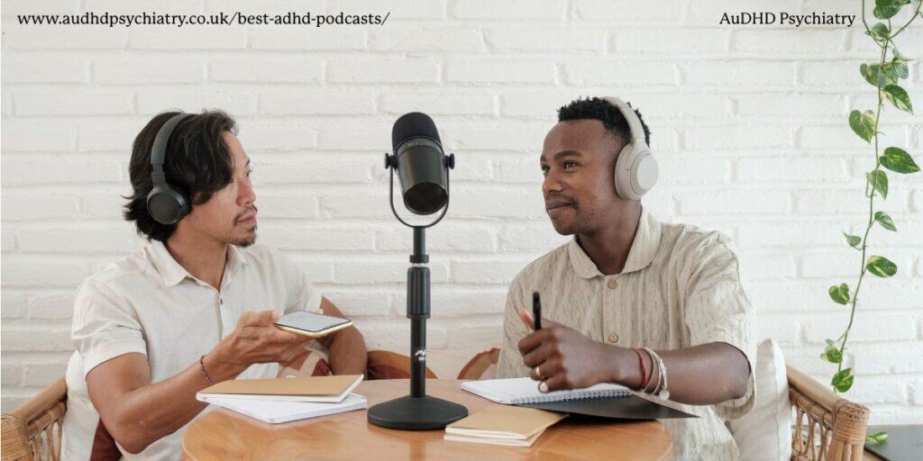 Two men hosting an ADHD podcast interview with microphones and notebooks, part of top ADHD channels roundup.