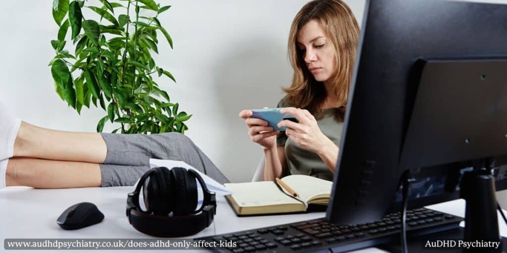 Adult woman distracted on phone demonstrating ADHD symptoms beyond childhood