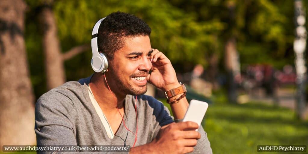Man listening to one of the best ADHD podcasts on his phone while outdoors with headphones.