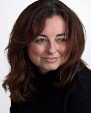 Confident woman with auburn hair looking to the side, representing mental health support and ADHD psychiatry services.