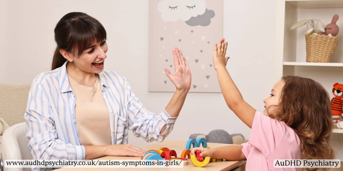 Therapist and child high-fiving – autism symptoms in girls and social development support