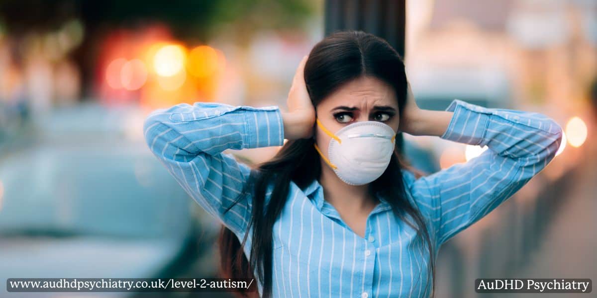 Woman covering ears in noisy street – sensory sensitivity in Level 2 autism