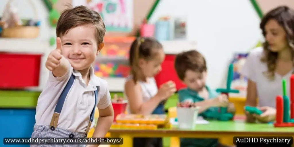 Young boy giving a thumbs up in a classroom, showing positive support strategies for ADHD in boys