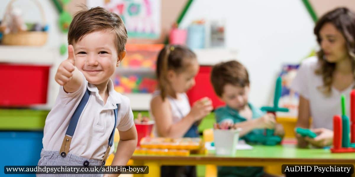 Young boy giving a thumbs up in a classroom, showing positive support strategies for ADHD in boys