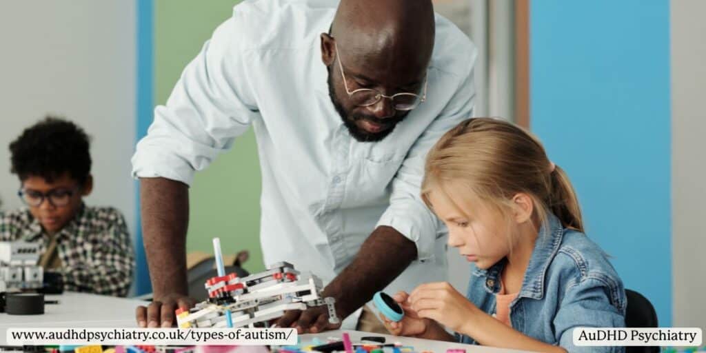 Teacher helping a young girl build with materials in class, demonstrating educational support for different types of autism