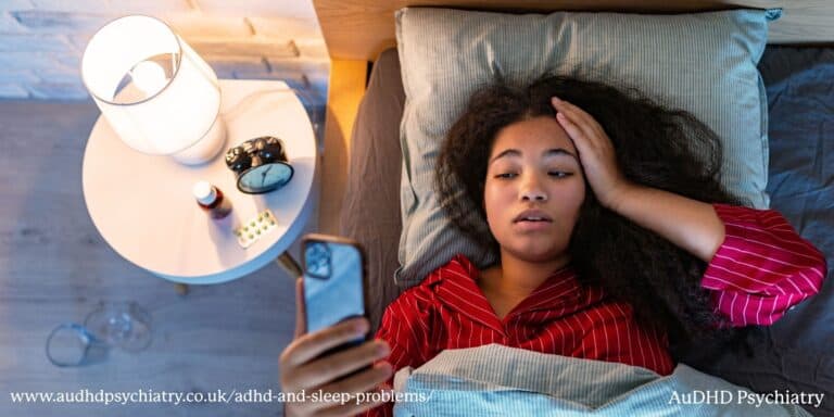 Woman lying in bed at night using her phone, illustrating ADHD and sleep problems and difficulty switching off