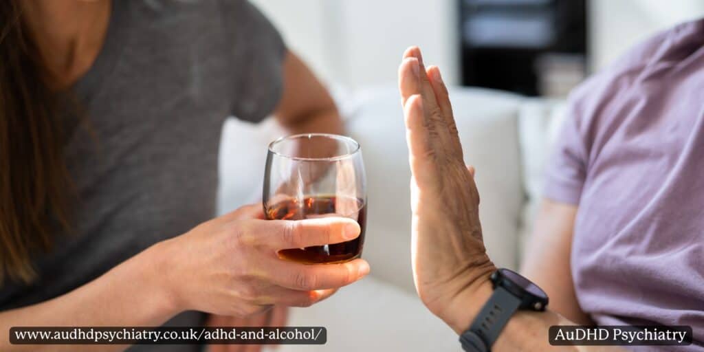 Person raising a hand to refuse a drink while someone holds a glass, representing boundaries around ADHD and alcohol