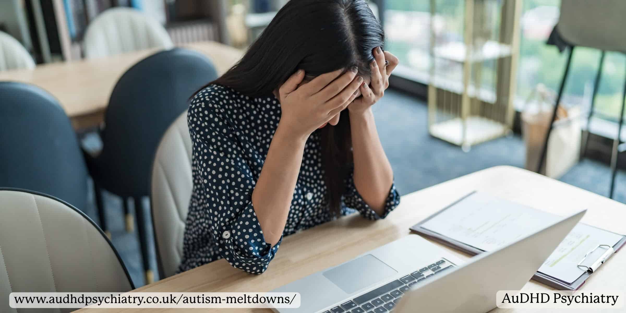 Woman experiencing emotional overwhelm and autism meltdowns while working on laptop