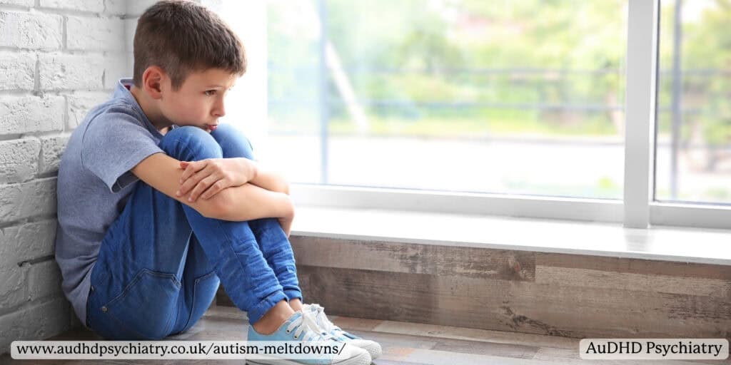 Autistic child sitting alone feeling distressed and overwhelmed near window