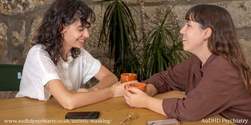 Two women socialising in café representing autistic masking during conversations