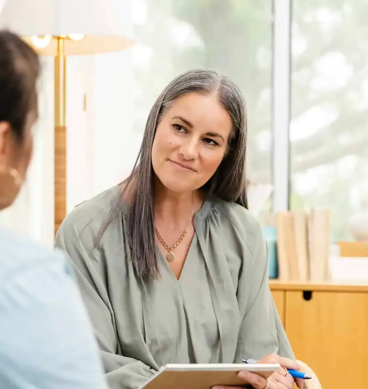 Clinician talking warmly with a woman during her combined ADHD and Autism assessment