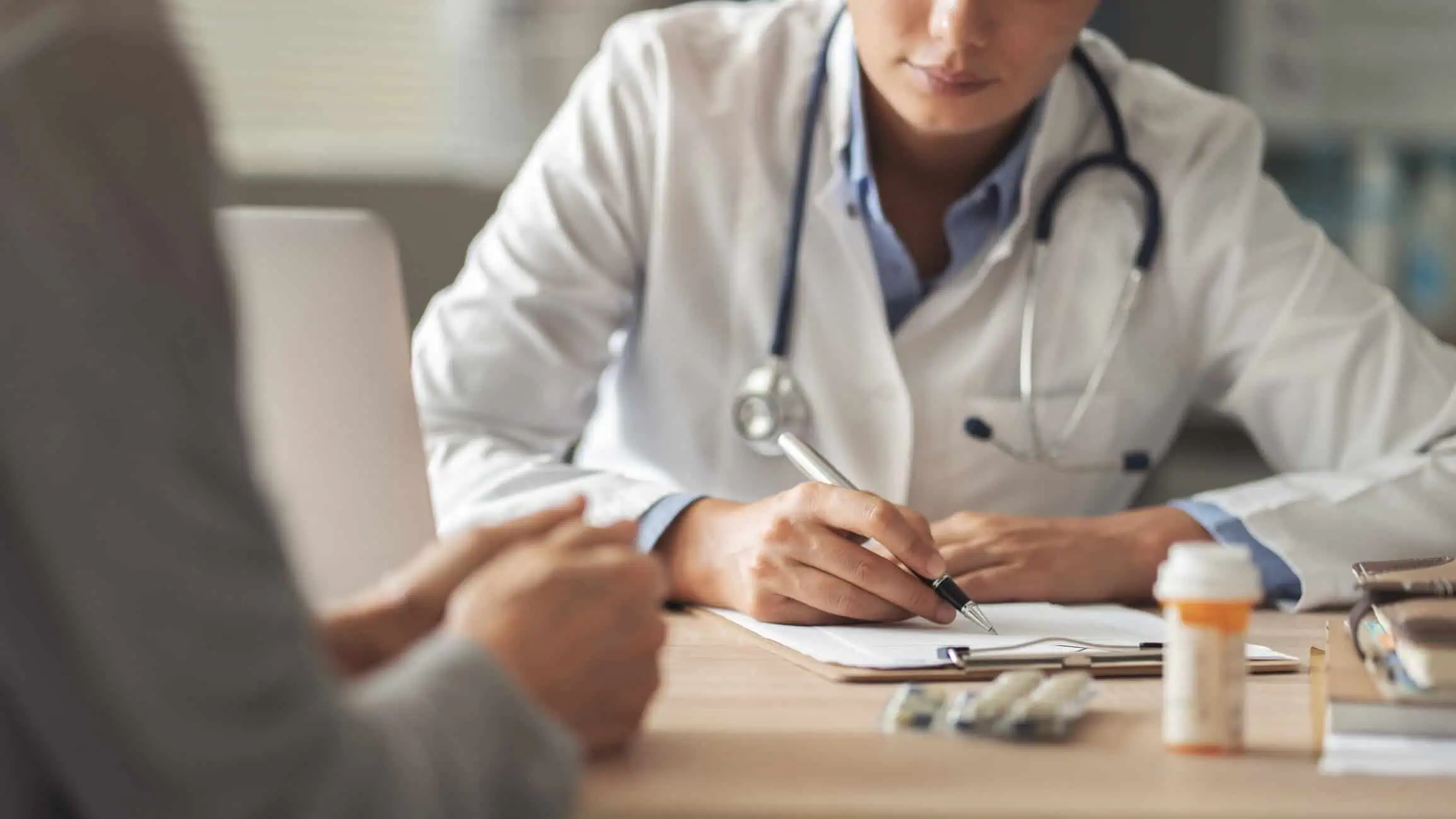 Doctor writing a prescription for ADHD medication during a consultation