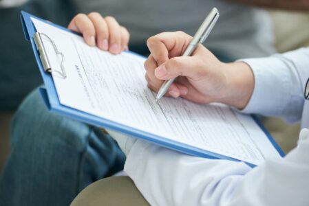 Crop doctor writing on clipboard